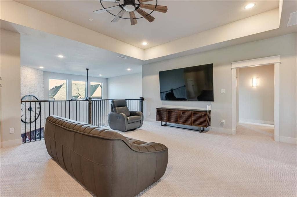 4102 Parkview Boulevard, Celina, TX 75009 Carpeted loft area with recessed lighting, a ceiling fan, and an open railing overlooking a lower level