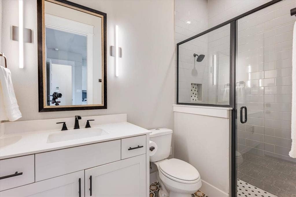 4102 Parkview Boulevard, Celina, TX 75009 White vanity with integrated sink, black hardware, and wall-mounted lighting