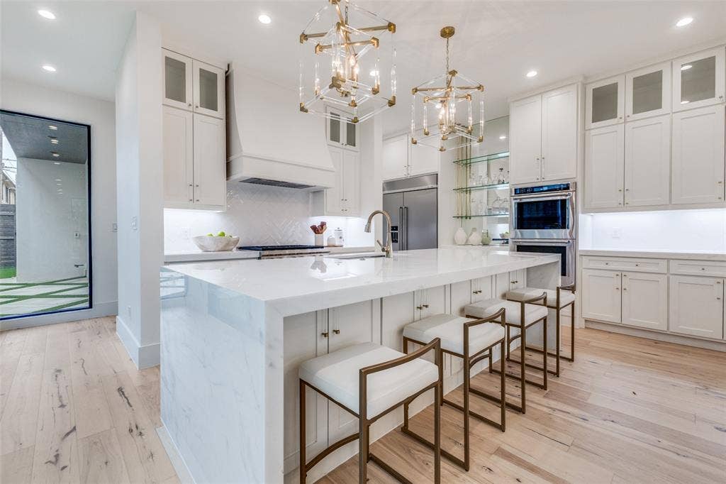 3629 McFARLIN Boulevard, University Park, TX 75205 Kitchen with marble waterfall island breakfast bar