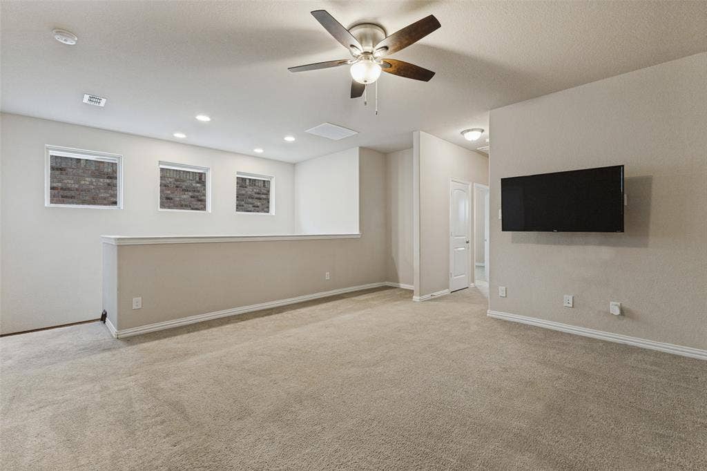 Oversized upstairs game room-living room with a ceiling fan, recessed lighting, and mounted TV