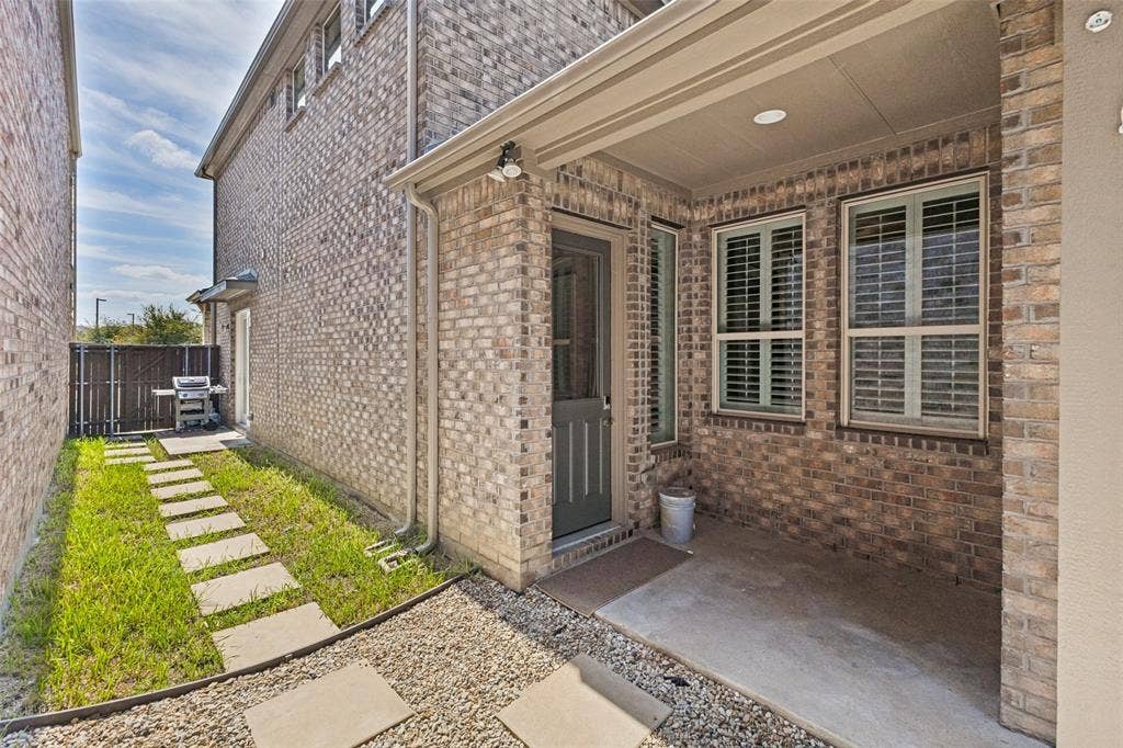 Covered area from garage to back entry of home.