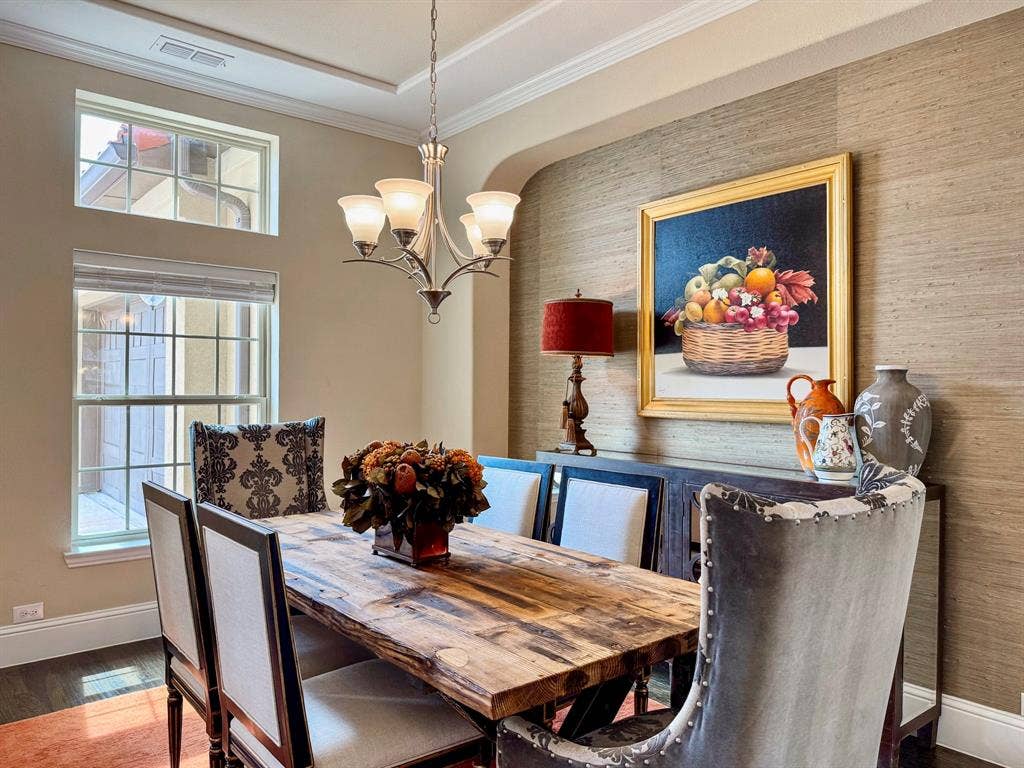 13018 Seattle Slew Street, Frisco, TX 75035 Tray ceiling with crown molding, chandelier lighting fixture, grasscloth wall covering, dark wood-finish flooring, and multi-pane windows