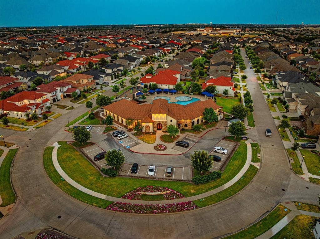 13018 Seattle Slew Street, Frisco, TX 75035 Community with a central amenity building, surrounding residences, and manicured green spaces
