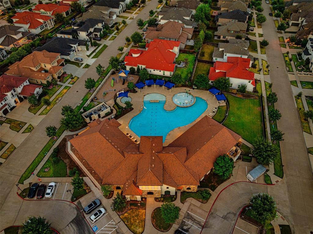 13018 Seattle Slew Street, Frisco, TX 75035 Community clubhouse with a multi-level pool, adjacent splash pad, and playground structure