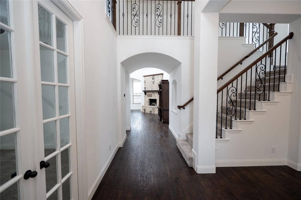Dark wood-finish flooring throughout the main corridor