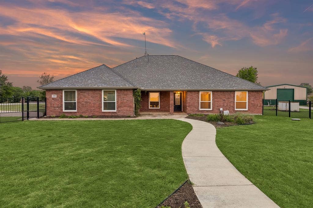 Stunning Homesite Framed By Lush Landscaping And Iron Fencing