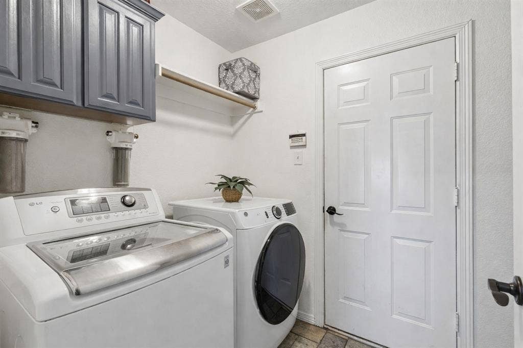 Large Laundry Room Featuring Cabinetry