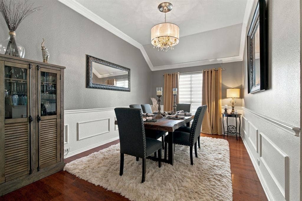 3106 Morning Dove, McKinney, TX 75072 Wood-finish flooring, wainscoting, crown molding, and a vaulted ceiling with a drum-style chandelier