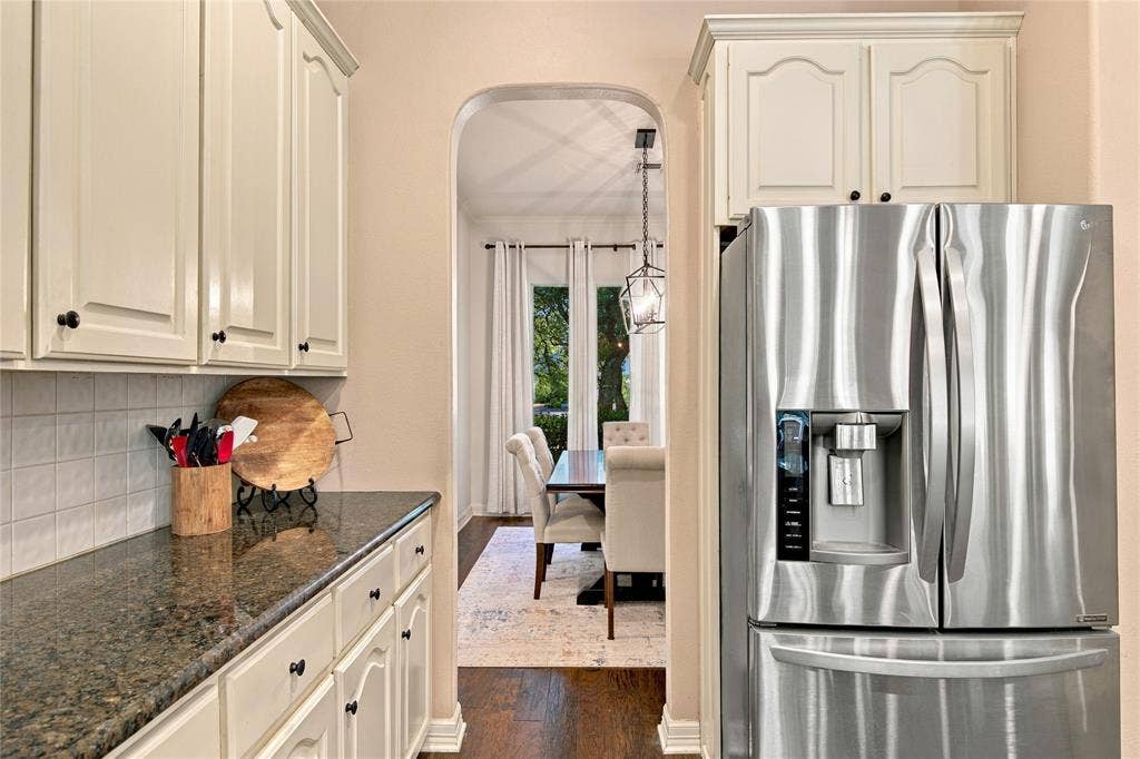 11408 Somerville Drive, Temple, TX 76502 Kitchen featuring white cabinetry, dark countertops, and a stainless steel refrigerator