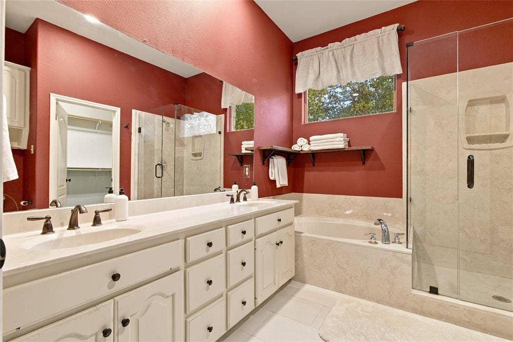 11408 Somerville Drive, Temple, TX 76502 Double vanity with undermount sinks, built-in bathtub, and a glass-enclosed shower