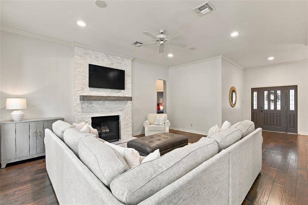 11408 Somerville Drive, Temple, TX 76502 Wood-finish flooring, recessed lighting, and a stacked stone fireplace with a substantial wood mantel