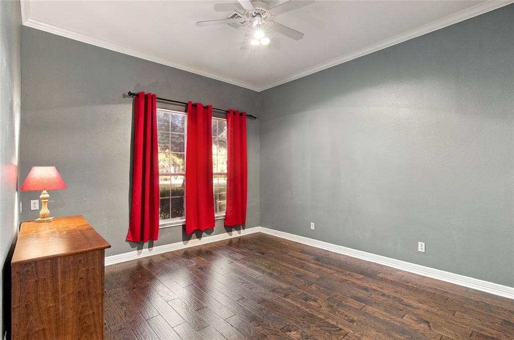 11408 Somerville Drive, Temple, TX 76502 Crown molding, rich wood-finish flooring, and a ceiling fan with integrated lighting
