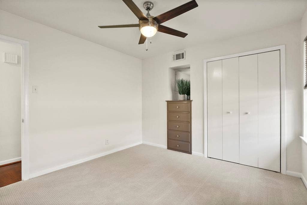 Light-colored carpeting with matching wall finishes