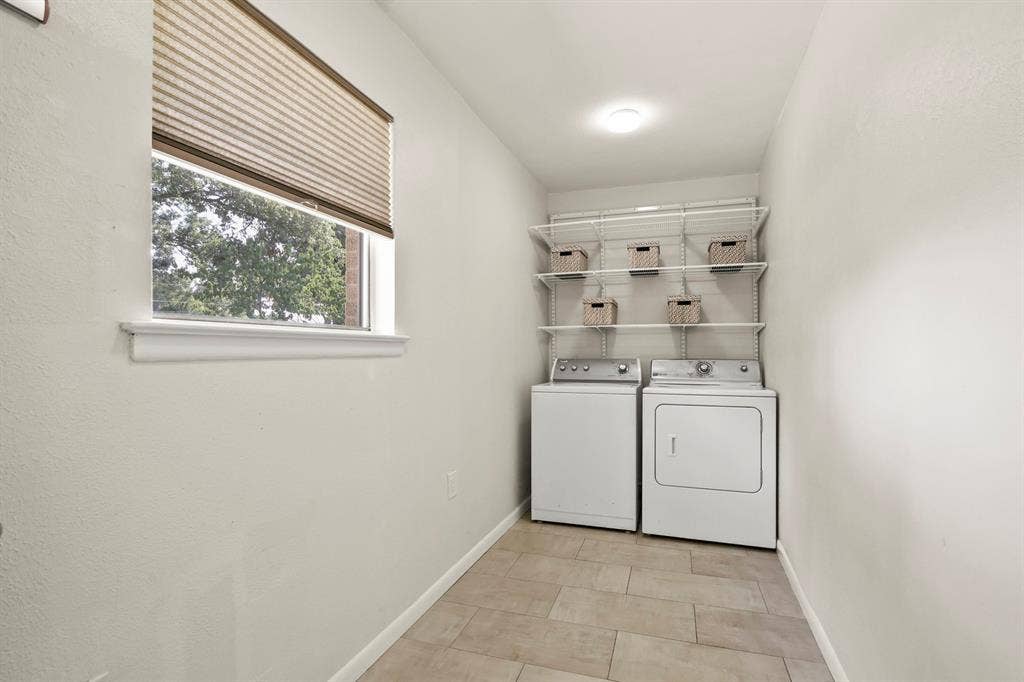 Recessed lighting, tile flooring, window with pleated shade, and built-in shelving system