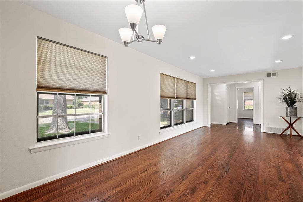 Wood-finish flooring, recessed lighting, and a contemporary chandelier