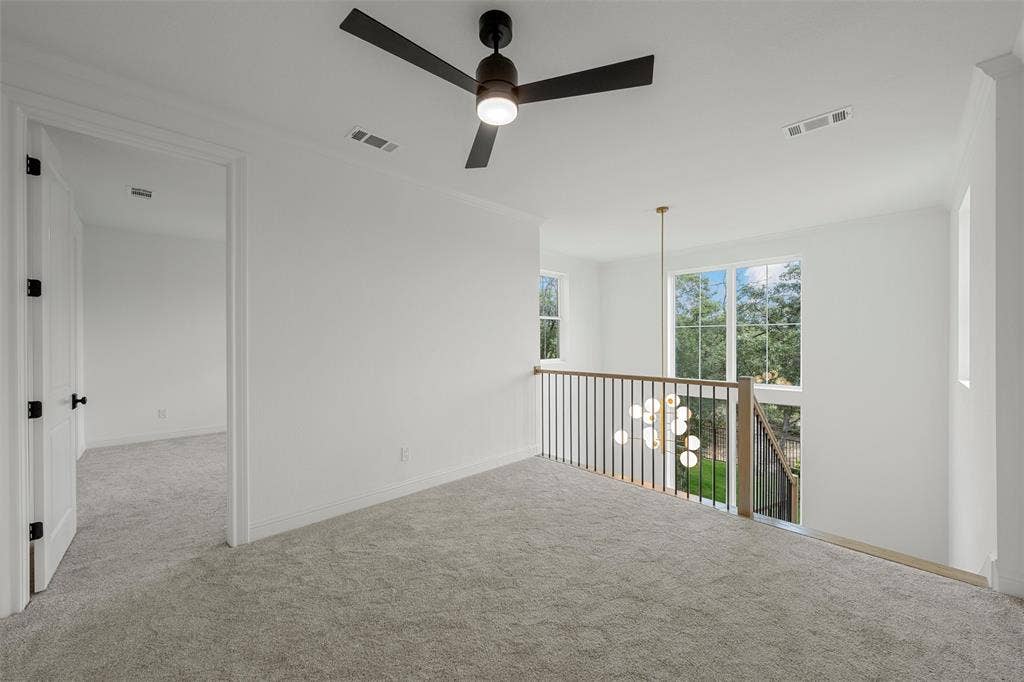 20 N Ritchie Road, Woodway, TX 76712 Carpeted landing with white walls, contemporary ceiling fan, and black metal railing