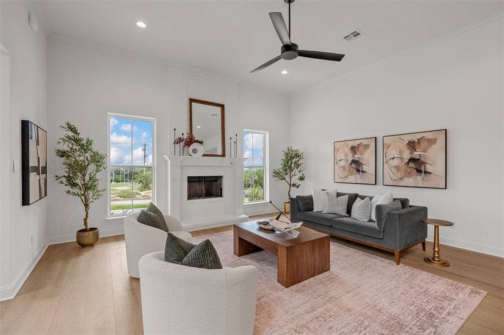 20 N Ritchie Road, Woodway, TX 76712 Vaulted ceilings, wood-finish flooring, recessed lighting, a fireplace with a mantel, and a ceiling fan