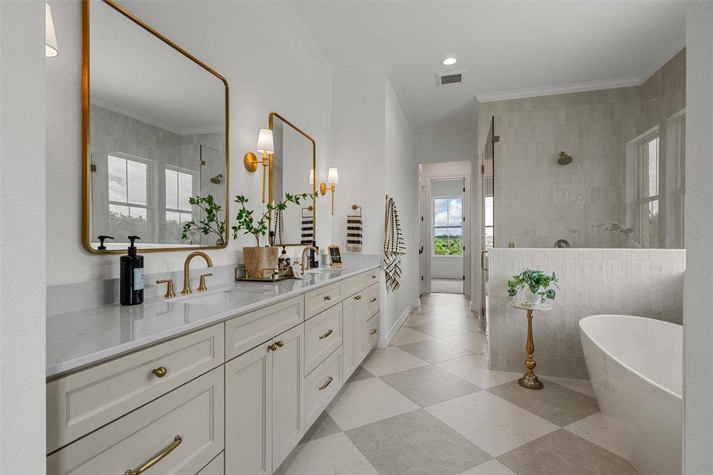 20 N Ritchie Road, Woodway, TX 76712 Dual vanity with white shaker cabinetry, gold-finish hardware, and a light-toned countertop