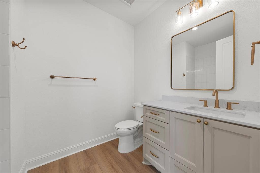 20 N Ritchie Road, Woodway, TX 76712 Vanity with a light-toned countertop, under-mount sink, and brass fixtures