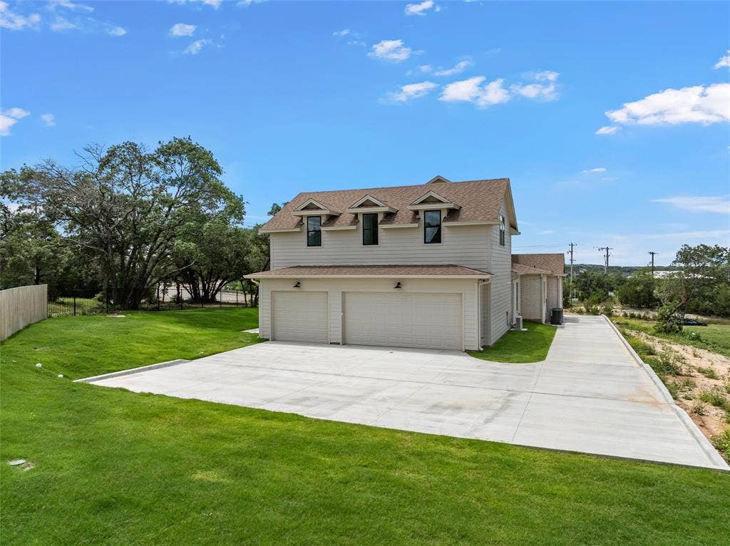 20 N Ritchie Road, Woodway, TX 76712 Two-story residence with a light-colored siding exterior and a multi-gabled roof