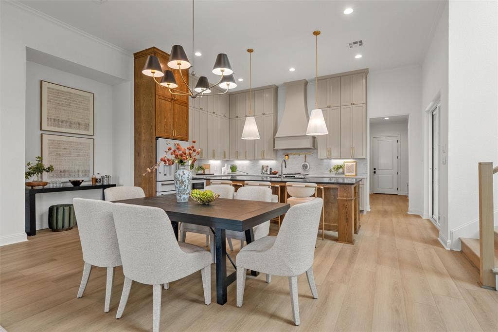 20 N Ritchie Road, Woodway, TX 76712 Open-concept living space with light wood-finish flooring, a contemporary chandelier, and recessed lighting