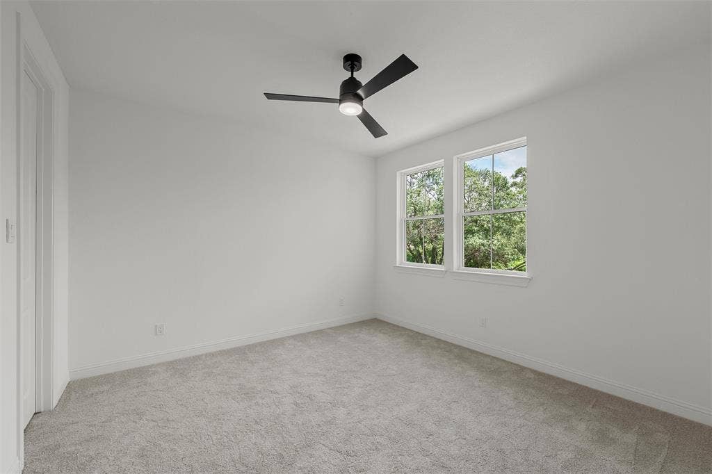 20 N Ritchie Road, Woodway, TX 76712 White walls, light gray carpet, and a modern black ceiling fan