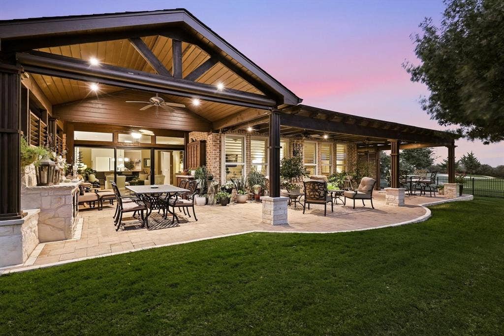 1641 Overwood Drive, Frisco, TX 75036 Expansive paver patio with a vaulted wooden ceiling, exposed wood beams, ceiling fans, and a pergola with wood beams