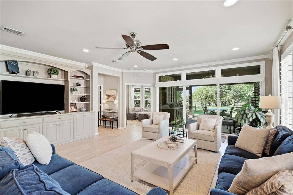 1641 Overwood Drive, Frisco, TX 75036 Built-in custom made cabinetry with open shelving, wood-finish flooring, ceiling fan and sliding windows with a view of golf course