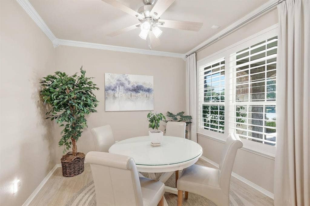 1641 Overwood Drive, Frisco, TX 75036 Crown molding accenting the ceiling, wood-finish flooring, two large windows with plantation shutters, ceiling fan with integrated lighting, and neutral wall tones