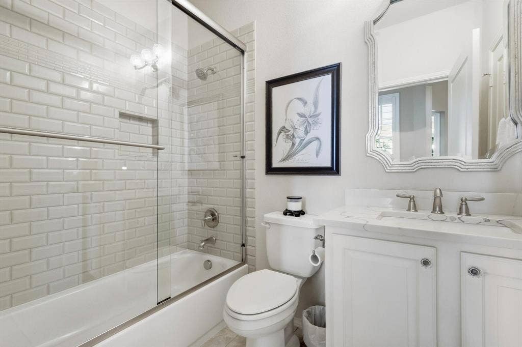 1641 Overwood Drive, Frisco, TX 75036 White subway tile shower surround with integrated niche, white cabinets and a Linen Closet