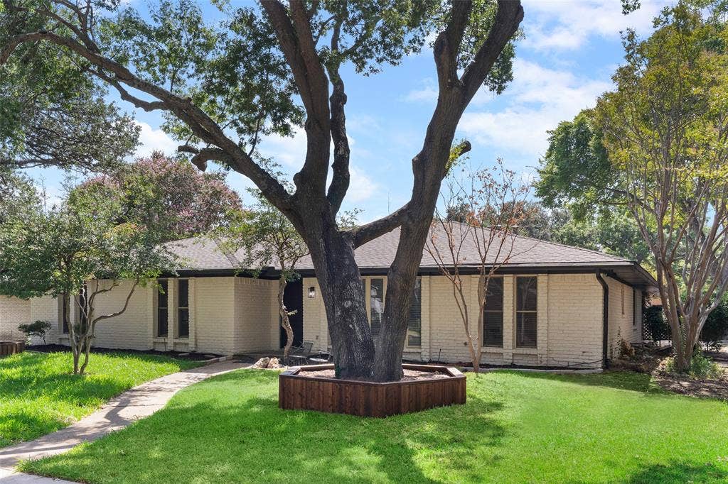 1612 Northcrest Drive, Plano, TX 75075 Brick exterior with a dark roof and mature trees