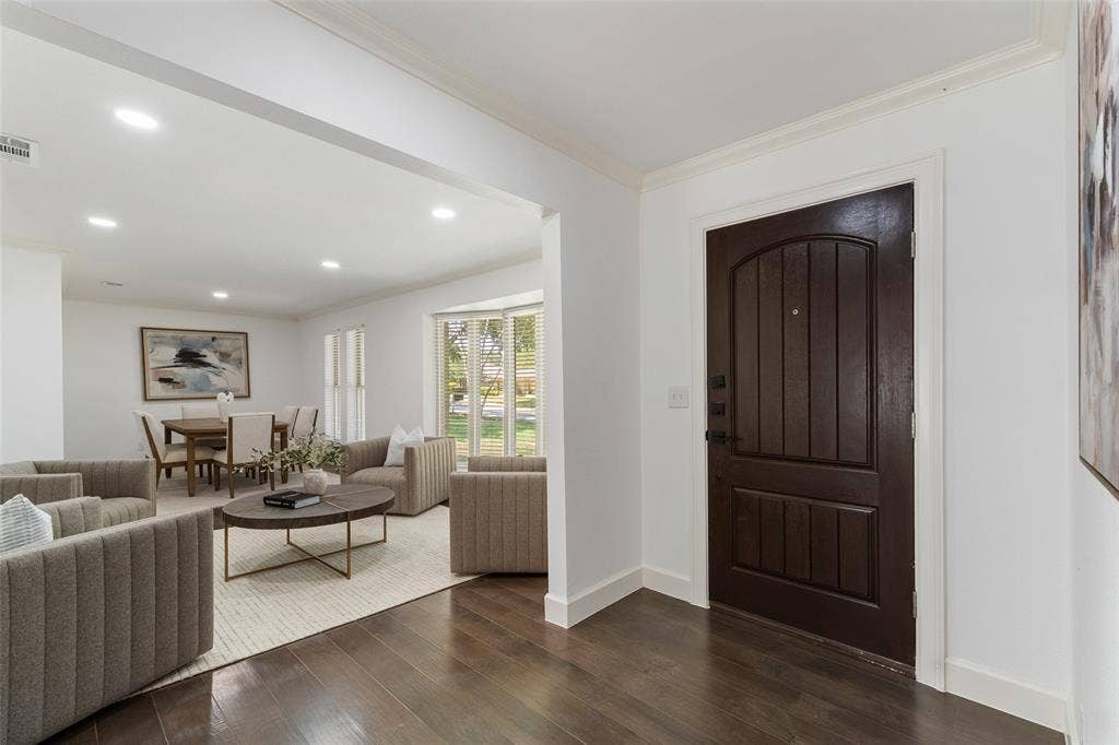 1612 Northcrest Drive, Plano, TX 75075 Dark wood-finish entry door, wide plank wood-finish flooring, recessed ceiling lighting, and a bay window
