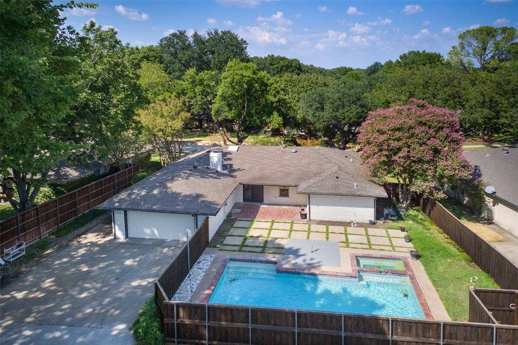 1612 Northcrest Drive, Plano, TX 75075 White exterior with a shingle roof, a swimming pool, and a spa