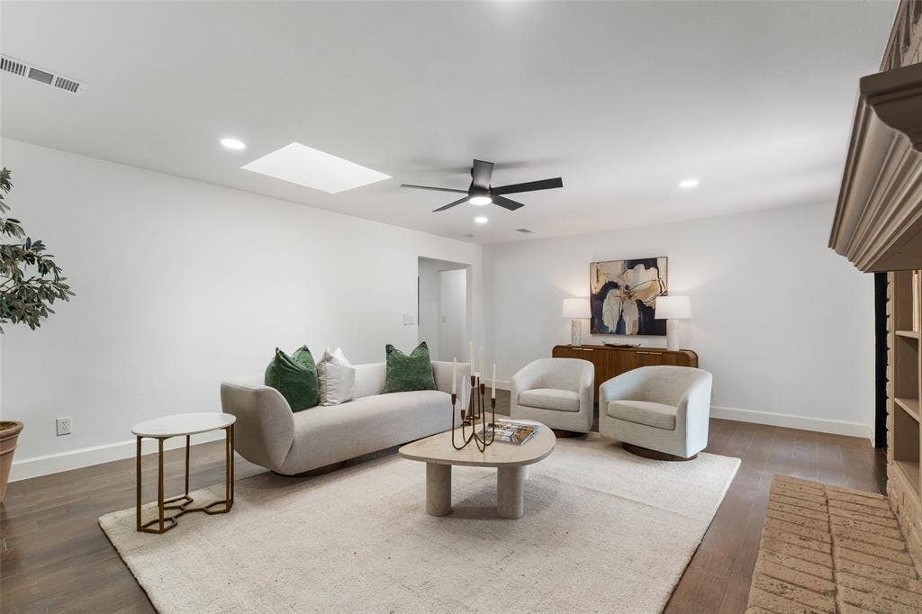 1612 Northcrest Drive, Plano, TX 75075 Recessed lighting, wood-finish flooring, a ceiling fan, and a skylight illuminate this living space
