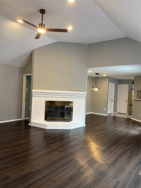 1120 Old Barn Lane, Mesquite, TX 75149 Vaulted ceiling with a ceiling fan, fireplace with a white brick surround, wood-finish flooring, and recessed lighting