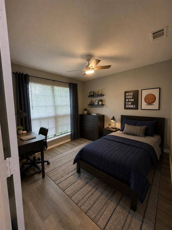 1120 Old Barn Lane, Mesquite, TX 75149 Wood-finish flooring, ceiling fan with integrated lighting, window with blinds, dark window treatments, and built-in wall shelving