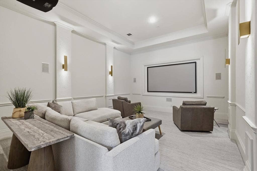 The main-level media room offers a comfortable, dedicated setting for movie nights and game days.