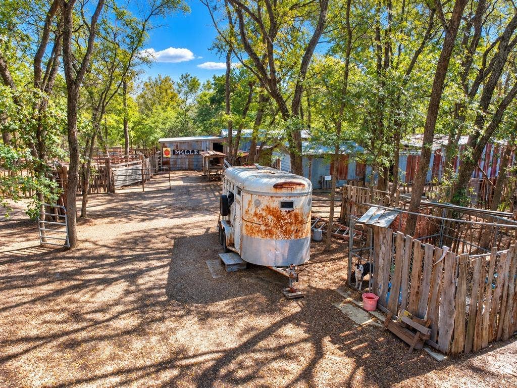 7245 County Road 4095, Kaufman, TX 75142 Expansive gravel yard with multiple fenced enclosures and mature shade trees