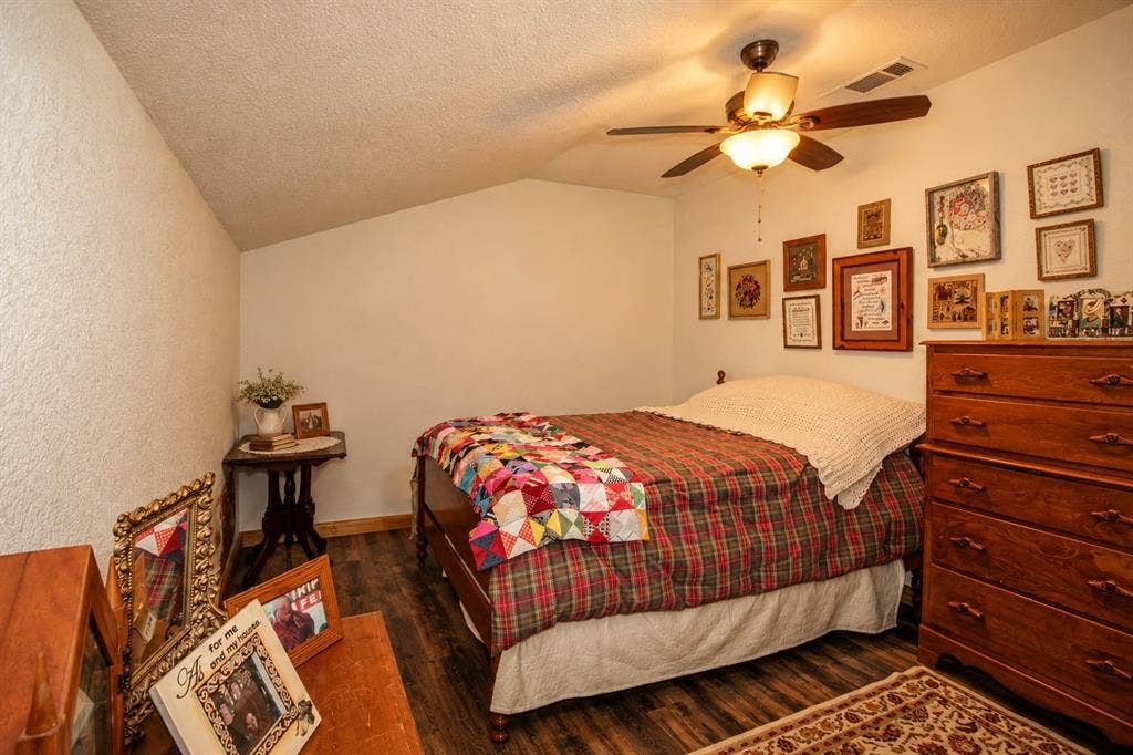 7245 County Road 4095, Kaufman, TX 75142 Wood-finish flooring, ceiling fan with integrated lighting, and a sloped ceiling