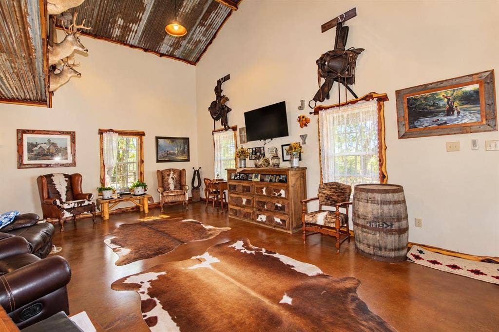 7245 County Road 4095, Kaufman, TX 75142 Vaulted ceiling with corrugated metal accent, light-toned walls, and wood-finish flooring