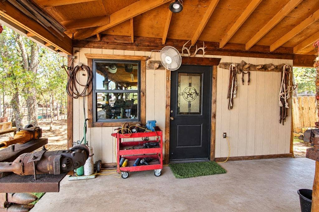 7245 County Road 4095, Kaufman, TX 75142 Covered concrete porch with exposed wood rafter ceiling