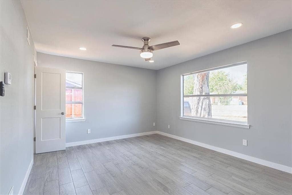 12326 Dandridge Drive, Dallas, TX 75243 Recessed lighting, ceiling fan with light kit.,Tile flooring, white trim, and a window with white casing