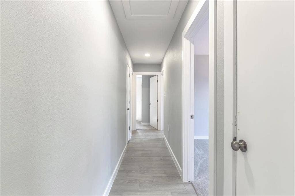 12326 Dandridge Drive, Dallas, TX 75243 Hallway featuring light grey tile flooring and recessed lighting