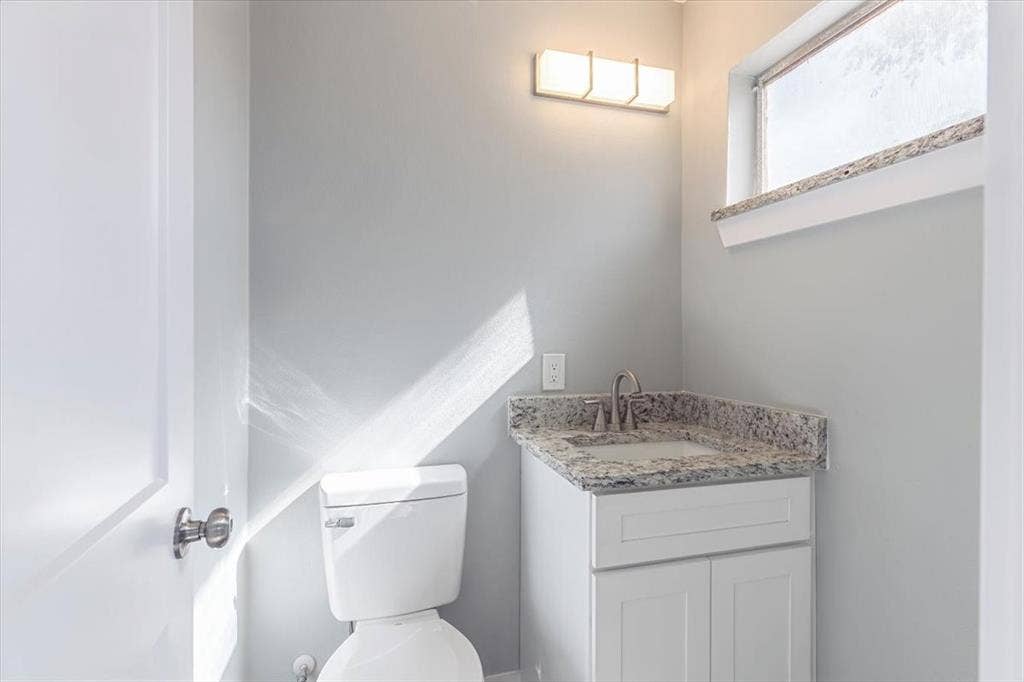 12326 Dandridge Drive, Dallas, TX 75243 Vanity with a granite countertop, undermount sink, and brushed nickel faucet