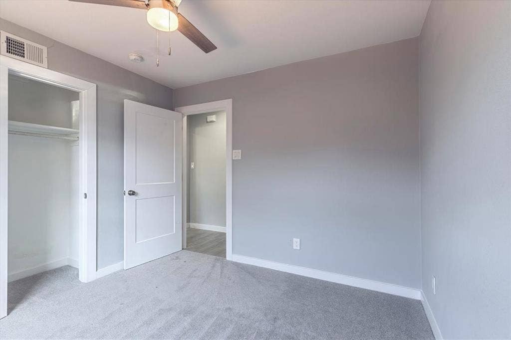 12326 Dandridge Drive, Dallas, TX 75243 Gray carpet white trim, and a ceiling fan with integrated lighting