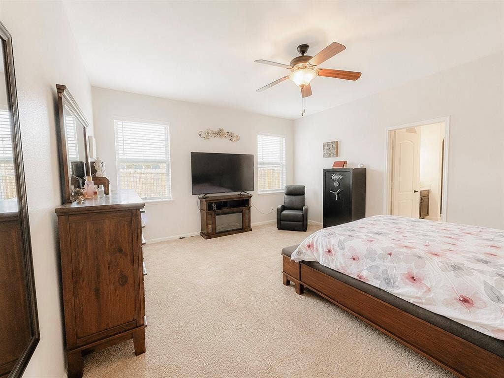 Recessed lighting, ceiling fan with light fixture, neutral carpeting, and multiple windows with blinds