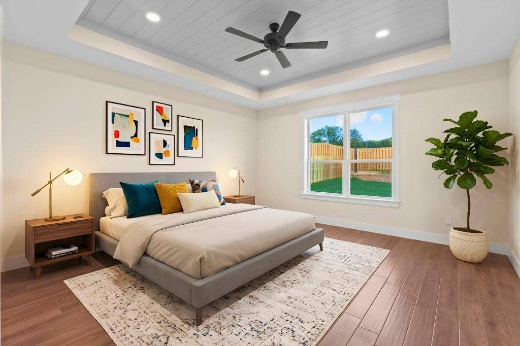 Tray ceiling with recessed lighting and ceiling fan, wood-finish flooring, and a large window