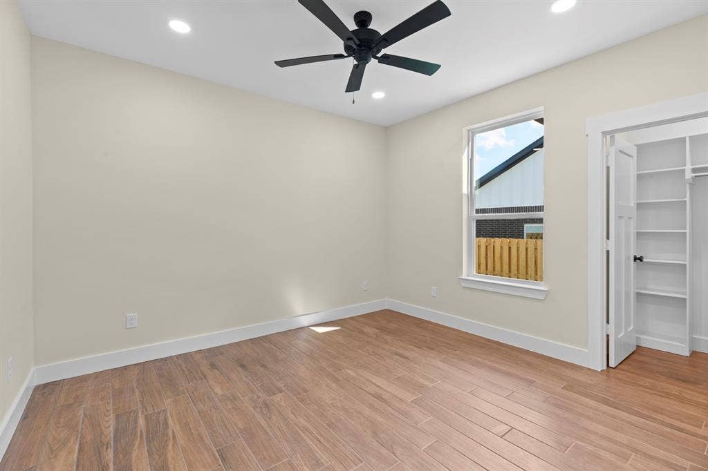 Wood-finish flooring, recessed lighting, and a contemporary ceiling fan