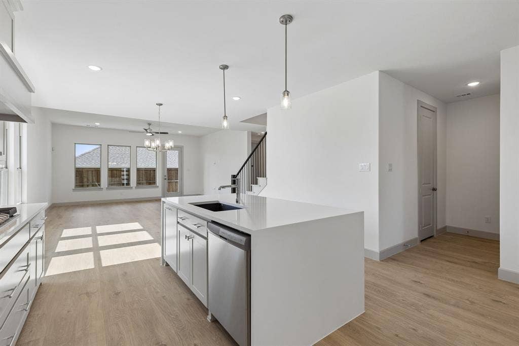 6901 Chief Spotted Tail Drive, McKinney, TX 75070 Open to the living and dining rooms, entertaining is a breeze in this great home!