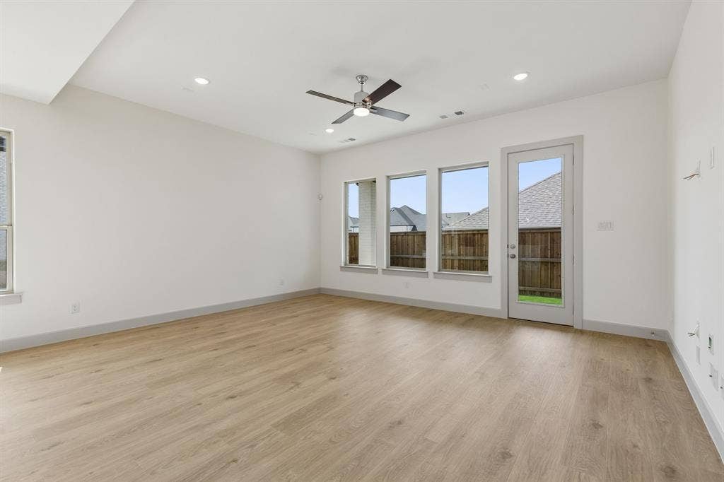 6901 Chief Spotted Tail Drive, McKinney, TX 75070 Light and bright, this family room is spacious enough to host the entire family!